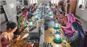  ?? Smita Sharma/New York Times ?? Women from villages near Tilonia, India, learn how to make solar lamps Monday at Barefoot College. This campus trains even illiterate people in skills leading to higher-paying jobs.