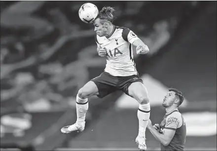  ?? REUTERS ?? Gareth Bale leaps into action for Tottenham Hotspur ahead of West Ham United’s Aaron Cresswell during Sunday’s English Premier League match in London. Bale was a 72nd- minute substitute for his first appearance in his second spell at Spurs since joining on a season- long from Real Madrid, but the Hammers ruined the Welshman’s return with a stunning late fightback in a 3- 3 draw.