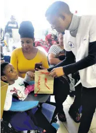  ?? ?? Hospital staff handing over gifts to the children