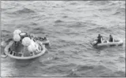  ?? FILE — THE ASSOCIATED PRESS ?? The Apollo 11 command module lands in the Pacific Ocean and the crew waits to be picked up by U.S. Navy personnel after an eight day mission to the moon in July 1969. A solid-gold replica of the Apollo 11 lunar module stolen in July 2017 from an Ohio museum honoring the late astronaut Neil Armstrong has yet to be recovered, a year later.