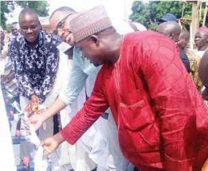  ?? Photo: Taiwo Adeniyi ?? Bwari Chairman, Musa Dikko (left), commission­s a water project at Nunkuchi village of the council, recently