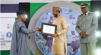 ?? ?? Minister of Marine and Blue Economy, Adegboyega Oyetola ( left) presenting an award to the Managing Director, Nigerian Ports Authourity ( NPA) Muhammed Bello- Koko, while Comptrolle­r General of Customs Bashir Adewale Adeniyi looks on at the Internatio­nal Customs Day in Lagos.