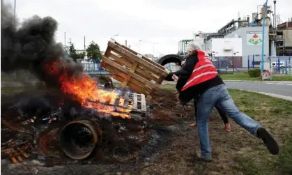  ?? Photograph: Benoît Tessier/ Reuters ?? Workers on strike burn a fire in front of the ExxonMobil oil refinery in Port-Jerome-sur-Seine on October 5.