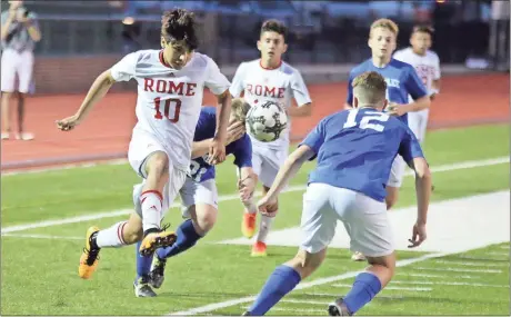  ?? Jeremy Stewart / Rome News-Tribune ?? Rome’s Sergio Vazquez (left) kicks the ball toward Chamblee’s Luke Littleton during a match in the Class 5A state playoffs Friday at Barron Stadium.