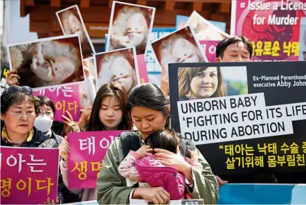  ??  ?? Standing up: Pro-life supporters rally against the lifting of the ban on abortion in front of the constituti­onal court in Seoul last week. - Reuters