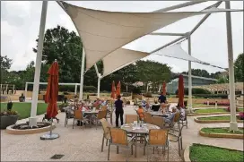  ??  ?? When weather permits, some residents enjoy their dinner on a terrace at Lenbrook Senior Community in Buckhead.