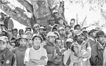  ?? — AFP photo ?? This file photo taken on Oct 6 in Soamahaman­ina shows people protesting the presence of the Jiuxing Chinese mining company near the mining site.