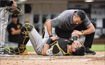  ?? DENIS POROY / GETTY IMAGES ?? Francisco Cervelli of the Pittsburgh Pirates is looked at by a trainer after being hit with a pitch in 2017. This month, Cervelli downplayed earlier comments suggesting that he would likely stop catching.