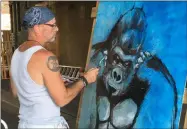  ?? RICHARD PAYERCHIN — THE MORNING JOURNAL ?? Artist James “The Rev” Giar, an Elyria native who paints with the Rust Belt Monster Collective muralists, works on a painting in the railroad underpass at the second annual Garford Arts Fest held Aug. 3. in downtown Elyria.