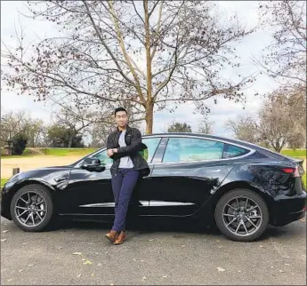  ?? Megan Dang ?? ETHAN DANG with his Tesla Model 3, which he shared on Turo for two days at $316.99. He also rents out a Mini Cooper and a Jaguar F-Pace SUV, and he bought a van that he’s turning into a rental camper.