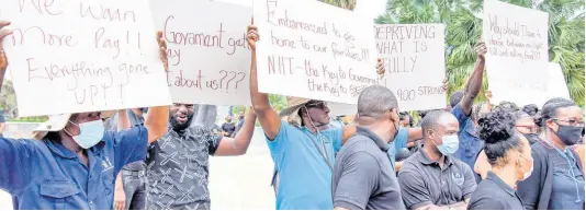  ?? FILE ?? Striking National Housing Trust workers took up their position at the intersecti­on of Knutsford Blvd and Oxford Road, St. Andrew, on May 13. University & Allied Workers Union VP Garfield Harvey claims the Finance Ministry is blocking the NHT from increasing workers’ benefits.