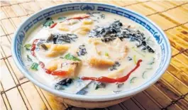 ?? AMY DREW THOMPSON/ORLANDO SENTINEL ?? Mild and silky, salt soy milk soup — dressed here with a bit of sriracha — is a breakfast staple in Shanghai.