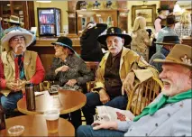  ?? KIM RAFF / THE NEW YORK TIMES ?? Visitors at the 34th National Cowboy Poetry Gathering socialize at G Three Bar in Elko. Heading into its 35th year, the National Cowboy Poetry Gathering is a heartfelt showcase for storytelli­ng, singalongs and good Basque cooking.