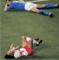  ?? JASON REED Reuters ?? SOUTH Korea’s Ahn Jung-hwan (bottom) reacts after missing a goal as Italy’s Mark Juliano lies on the ground during their World Cup match in 2002. |