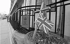  ?? AGENCE FRANCE PRESSE ?? A Union Flag attached to a cross stands in a plant outside the King Edward VII hospital in central London.