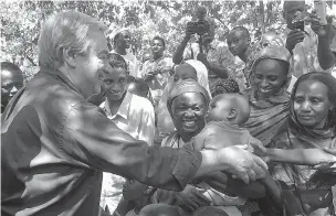  ?? JOEL KOUAM/THE ASSOCIATED PRESS ?? U.N. Secretary-General Antonio Guterres, left, shakes hands Wednesday with people at Bangassou Cathedral Bangui, Central African Republic. Surrounded by hostile Christian militias, Muslim civilians in the volatile Central African Republic town of...