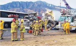  ?? KMIR-TV/AP ?? Emergency personnel work at the scene of a crash between a tour bus and a semi-truck on Interstate 10 near Desert Hot Springs in California’s Mojave Desert on Sunday. Thirteen people were killed and 31 injured.