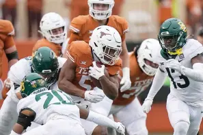  ?? (AP Photo/Eric Gay) ?? Texas running back Bijan Robinson (5) runs against Baylor Friday during the second half of an NCAA college football game in Austin, Texas.