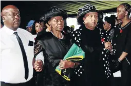  ?? / MDUDUZI NDZINGI ?? Dorcas Baby Mabalane, holding a flag, at the funeral service of her husband Professor Keorapetse ‘Bra Willie’ Kgositsile in Johannesbu­rg yesterday.