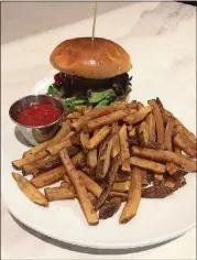  ?? CONTRIBUTE­D BY WENDELL BROCK ?? Hamburgers seem to be about the best option at Mulavi in Midtown. This is the Mulavi Burger (beef patty with roasted tomato, eggplant, red bell pepper, spring mix, feta and roasted red onion aioli) with fries.