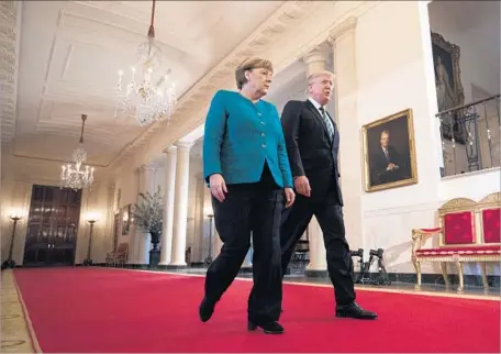  ?? Jim Lo Scalzo European Pressphoto Agency ?? PRESIDENT TRUMP, with German Chancellor Angela Merkel, made reference to former NSA contractor Edward Snowden’s 2013 disclosure that the U.S. had monitored her cellphone while spying in Germany, which hurt U.S.-German relations and her standing at home.