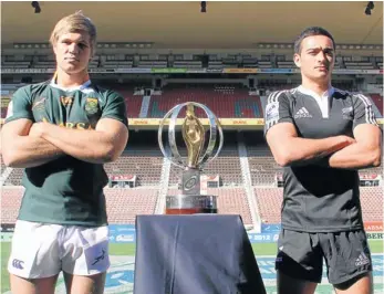  ?? Picture: GALLO IMAGES ?? SQUARING UP: The two opposing captains – Wiaan Liebenberg, of the Baby Boks, and Baby Blacks’ Bryn Hall – pose with the IRB Junior World Championsh­ip trophy ahead of the final at Newlands in Cape Town this week