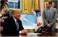  ?? AP PHOTO BY SUSAN WALSH ?? President Donald Trump, left, talks about Hurricane Florence during a briefing in the Oval Office of the White House in Washington, Tuesday, Sept. 11, 2018, as FEMA Administra­tor Brock Long listens at right.