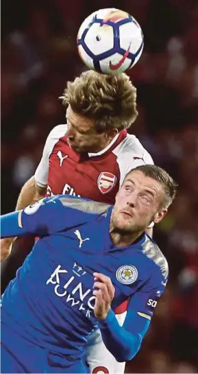  ?? AFP PIC ?? Leicester City’s Jamie Vardy (front) and Arsenal’s Nacho Monreal battle for the ball at the Emirates Stadium on Friday.