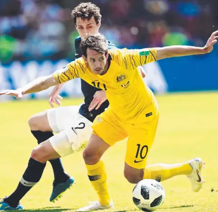  ?? SURREAL EXPERIENCE: Socceroos star Robbie Kruse tussles with France’s Benjamin Pavard during Saturday’s 2- 1 loss. Picture: AFP ??