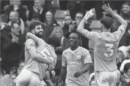  ?? AFP ?? Manchester City players celebrate the team’s fifth goal during its English Premier League match against Luton Town at the Etihad Stadium in Manchester, on Saturday. City won 5-1.