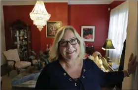  ?? STEVEN SENNE — THE ASSOCIATED PRESS ?? Airbnb operator Jennifer McConnell stands for a photograph in a communal area of her home, in Cambridge, Mass., on Sept. 13. College towns like Cambridge say they are feeling the pinch in the debate over whether short term rental sites like Airbnb have...