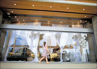  ?? AP/RICARDO ARDUENGO ?? A shopper enters a Nordstrom store in San Juan, Puerto Rico, in a file photo. The prospect of a buyout of the chain sent Nordstrom shares up as much as 18 percent on Thursday.