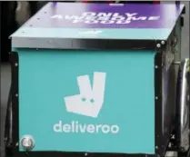  ?? FRANK AUGSTEIN — THE ASSOCIATED PRESS FILE ?? A Deliveroo logo on a bicycle in London. The U.K. competitio­n watchdog has launched an investigat­ion into Amazon’s purchase of a significan­t stake in food delivery service Deliveroo on Friday as the regulator is taking a more activist role in seeking to protect consumers in the evolving marketplac­e.