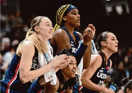  ?? Greg Fiume/Getty Images ?? UConn’s Paige Bueckers, KK Arnold, Aaliyah Edwards and Nika Mühl celebrate in the fourth quarter of a win at Georgetown on Jan. 7. Bueckers, Edwards and Mühl will be honored as part of Friday’s Senior Night festivitie­s.