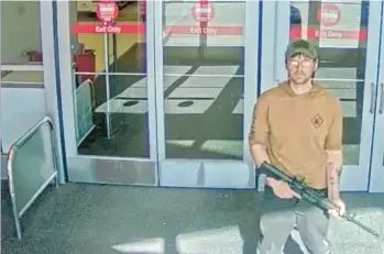  ?? OMAHA POLICE DEPARTMENT ?? In an image from security camera footage, a man identified as Joseph Jones and armed with an Ar-15-style rifle stands Jan. 31 at a Target store in Omaha, Neb. Despite having schizophre­nia. Jones was able to buy guns legally.