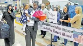  ?? AP FILE ?? n A Somali refugee who had been stuck in limbo after President Donald Trump temporaril­y banned refugee entries, walks with his wife and his daughter at Salt Lake City airport.