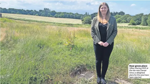  ?? ?? Dear green place Gillian Mackay MSP, at the site near Davaar Drive, is delighted plans for the area have been rejected