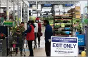  ?? MARK SCOLFORO - THE ASSOCIATED PRESS ?? Customers get checked out from the garden center at a Lowe’s store in Harrisburg, Pa., Wednesday, May 6. As swaths of Pennsylvan­ia prepare for a limited reopening Friday, some fed-up business owners are jumping the gun and have resumed serving customers in defiance of Gov. Tom Wolf’s shutdown order.