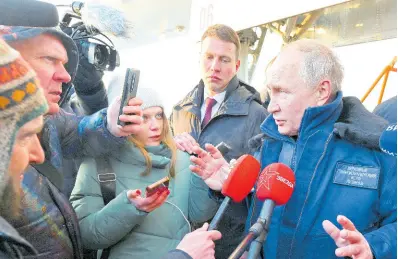  ?? AP ?? Russian President Vladimir Putin speaks to journalist­s as he gets off a Tu-160M strategic bomber after a flight in Kazan, Russia, yesterday.