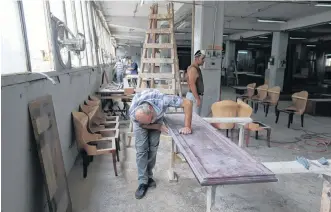  ?? AZIZ TAHER REUTERS ?? Men work inside Sleep Comfort furniture factory that was damaged during the Beirut port blast Aug. 13. The business lost one-third of its furniture and expect losses are around $600,000. •