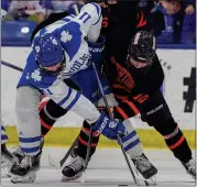  ?? TIMOTHY ARRICK — MEDIANEWS GROUP, FILE ?? Detroit Catholic Central’s Brooks Rogowski, left, and Brighton’s Landen Whitlock battle on a faceoff March 9 USA Hockey Arena. Rogowski was selected in the second round of the recent Ontario Hockey League draft.