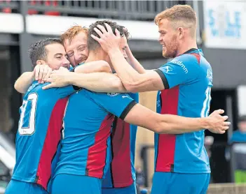  ?? ?? Cammy Harper, centre, is mobbed by his delighted team-mates after scoring