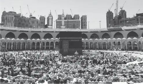  ?? KHALIL HAMRA / THE CANADIAN PRESS FILES ?? Muslims pray at the Grand Mosque in Mecca ahead of the hajj pilgrimage last year. Canadian Muslims considerin­g making the trip this year are feeling anxious about travelling to Saudi Arabia amid the recent tensions between the two countries and are asking travel agencies for refunds.