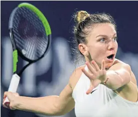  ??  ?? Simona Halep returns the ball to Jennifer Brady.