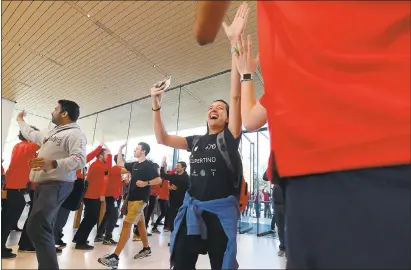  ?? PHOTOS: DAN HONDA — STAFF ?? The opening of the Apple Park Visitor Center brought in fans like Marilia Fonseca, of Brazil, who high-fives employees as she enters Friday.