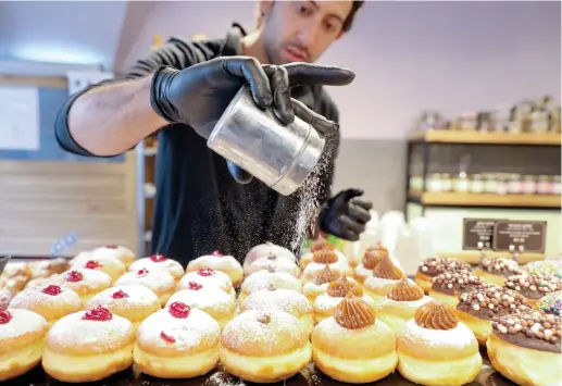  ?? (Marc Israel Sellem) ?? NO SHAME: You may have eaten sufganiyot blanketed in sugar over Hanukkah – and that’s OK.