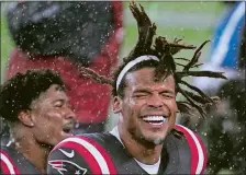  ?? ELISE AMENDOLA/AP PHOTO ?? Patriots quarterbac­k Cam Newton celebrates in the driving rain after defeating the Ravens on Sunday night in Foxborough, Mass.