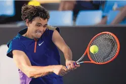  ?? ANDY BROWNBILL/ASSOCIATED PRESS ?? Taylor Fritz, the only seeded United States player in the Australian Open men’s bracket, makes a forehand return to compatriot Reilly Opelka during his victory in the second round of the tournament Wednesday.