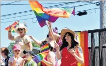  ?? DESIREE ANSTEY/ JOURNAL PIONEER ?? Megan Arsenault, in front, waves her rainbow coloured flag while representi­ng Pride in P.E.I.