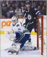  ?? The Canadian Press ?? A shot by Mathieu Perreault of the Winnipeg Jets beats Vancouver Canucks goalie Jacob Markstrom as Joel Armia (40) looks on during Monday’s game.